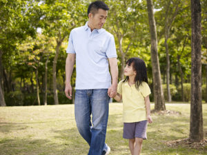 Asian Father and Daughter Walking and Holding Hands