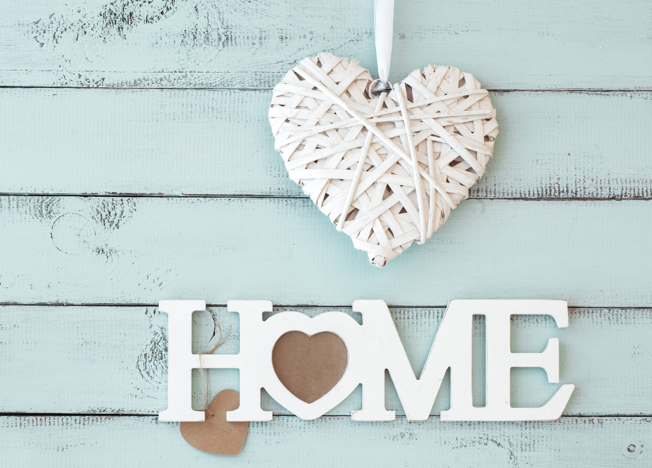 Home in wooden letters and a white heart